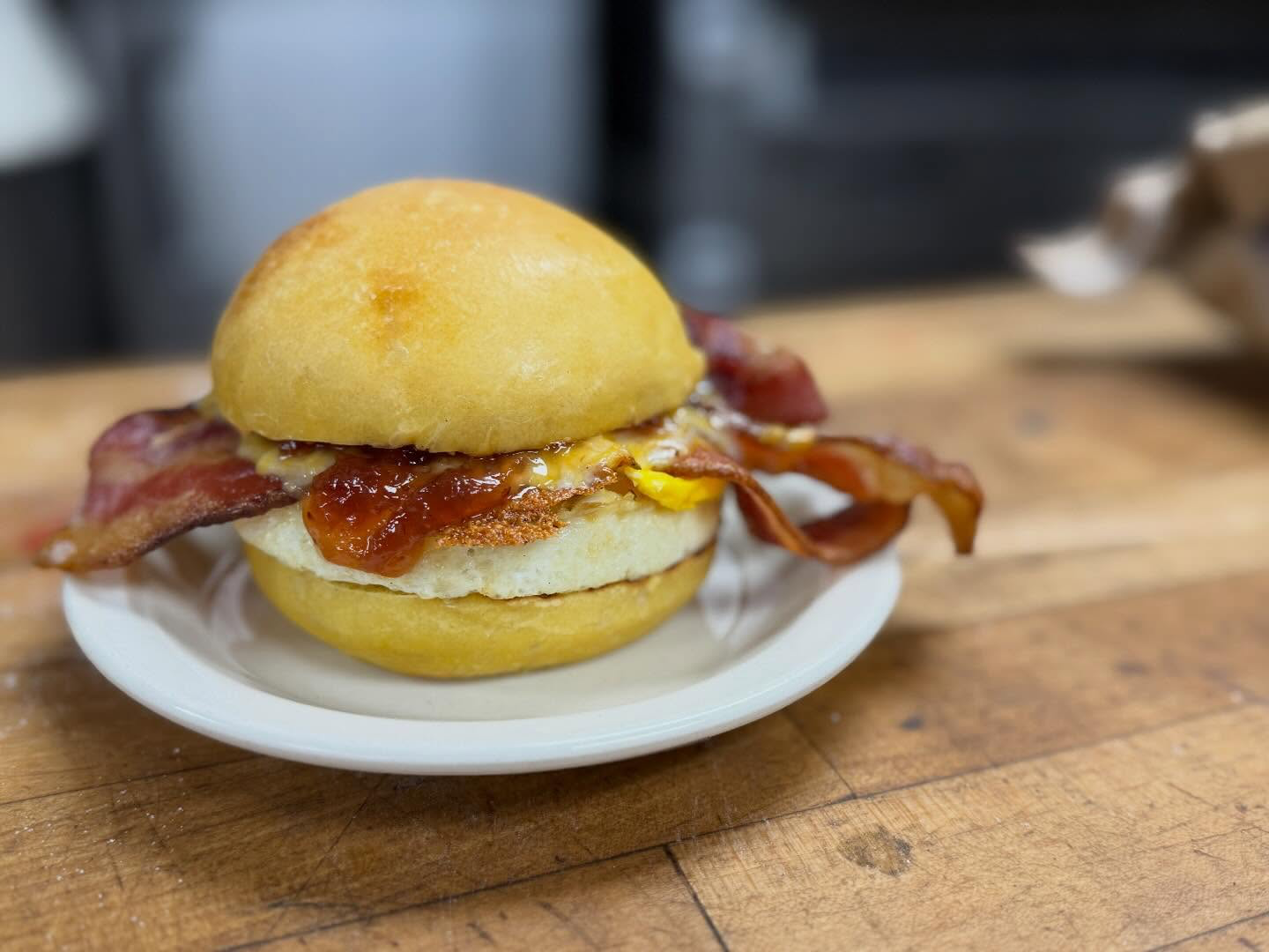 Egg, bacon, and house jam on a fresh-baked biscuit